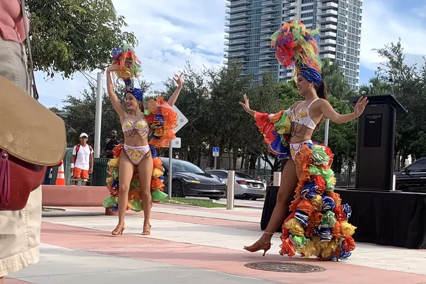 Two dancers dressed in tropical costumes