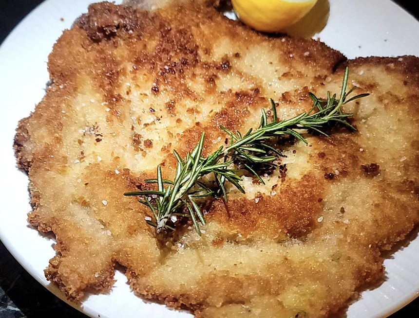 a meat dish on white plate