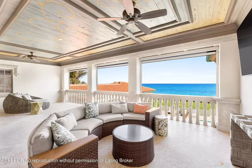 Covered outdoor balcony with seating, offering stunning views of the Atlantic Ocean