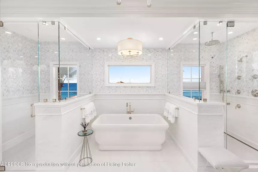 Freestanding soaking bathtub with floor-to-ceiling windows overlooking the ocean