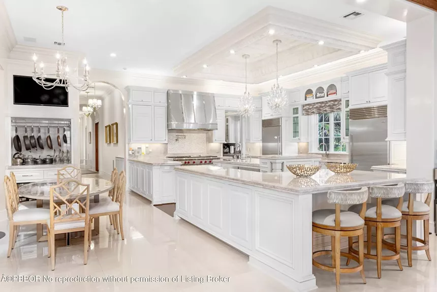 Expansive kitchen with marble countertops, modern appliances, and a large island