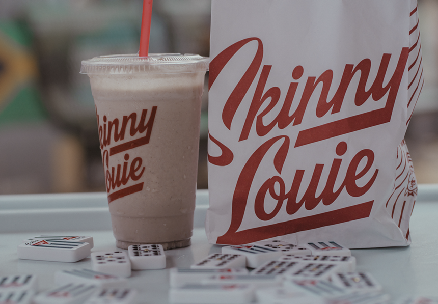 a shake on a table by a bag