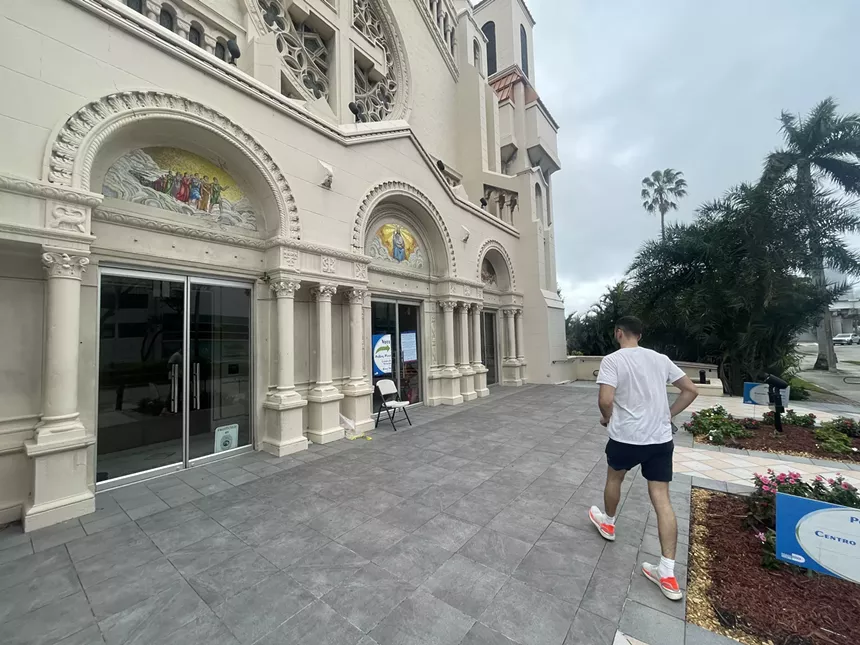 a man walking into a polling station