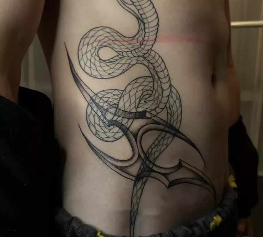 Man with tattoo on lower abdomen