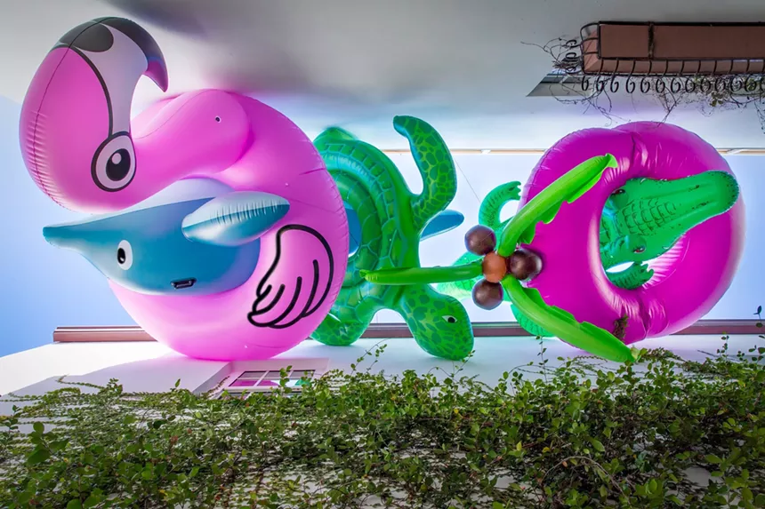 Oversized inflatables hanging over an alleyway in Miami Beach
