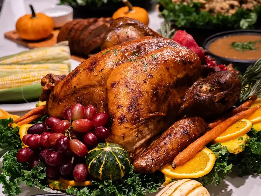 turkey with grapes, carrots, oranges and corn
