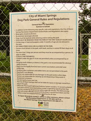 A sign at the City of Miami Springs dog park that lists 20 rules, including, in all-uppercase type: "NO UNNEUTERED DOGS."