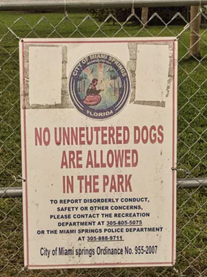 A City of Miami Springs sign stating no unneutered dogs are allowed in the park.