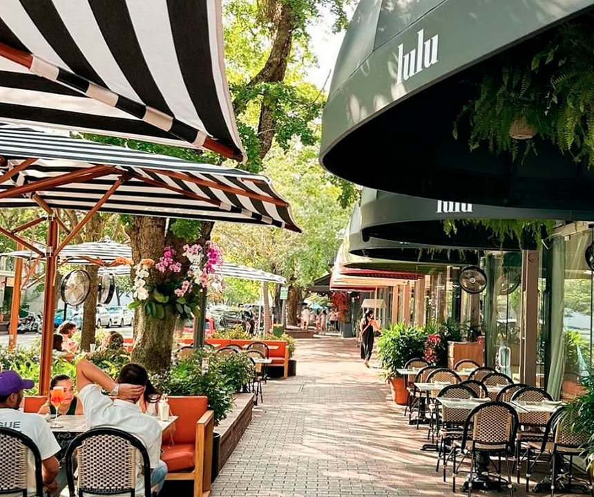exterior of restaurant with black and white awnings