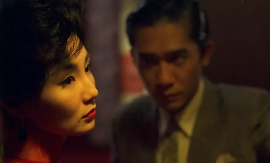 a close-up still of Maggie Cheung (left) and Tony Leung (right), from the film In the Mood for Love