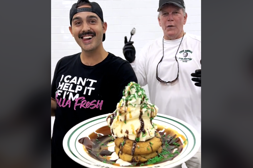 two men holding dessert plate