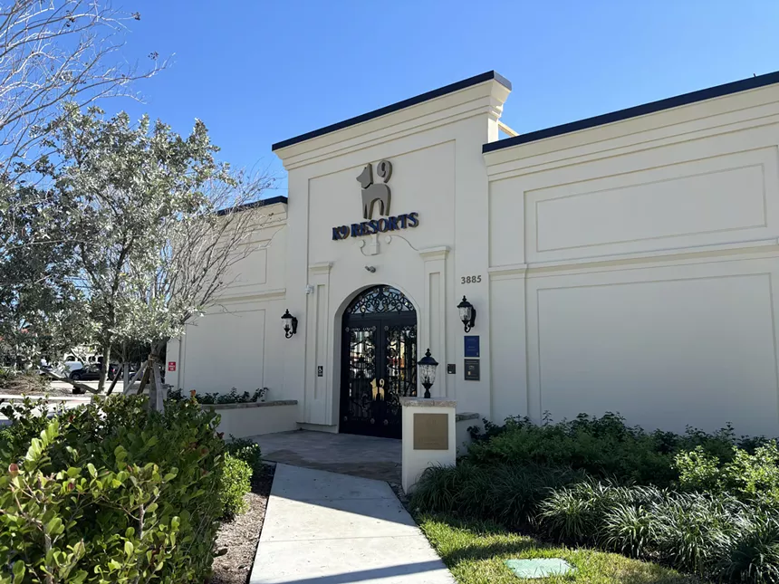 the facade of a hotel with a sign reading K9 Resorts