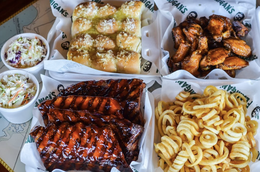fries, baby back ribs, and bread on a table