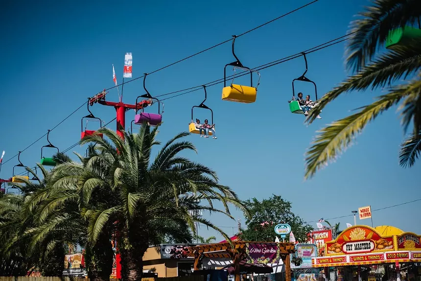 A lift transporting people above the fair