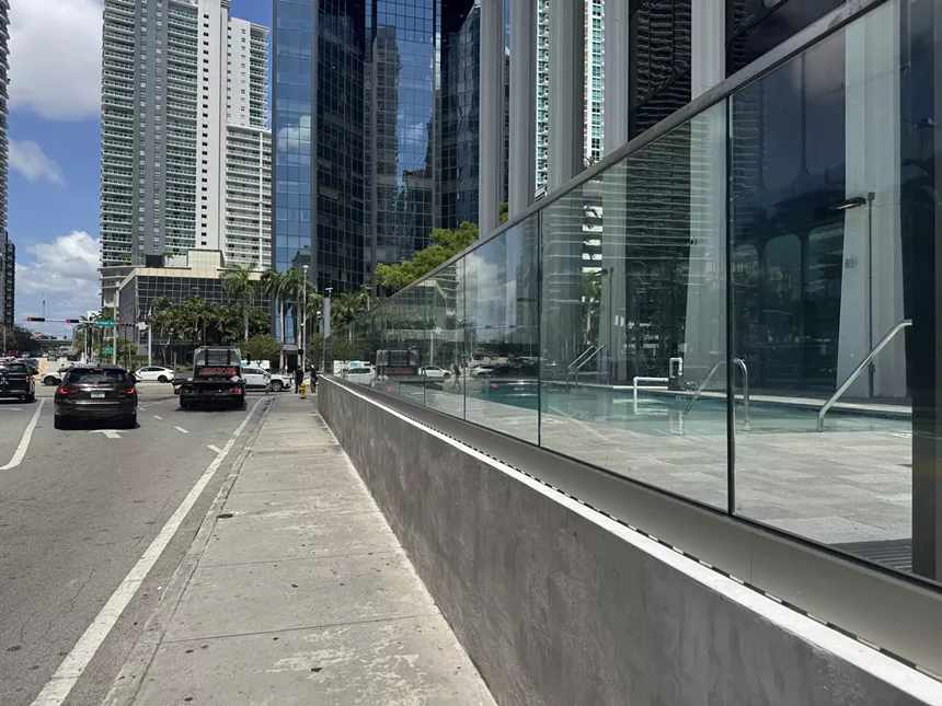 A pool next to the cars on the street in Brickell.