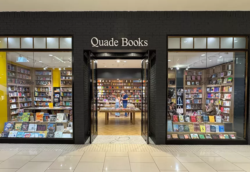 Facade of a bookstore inside a mall. The store's name reads, "Quade Books."