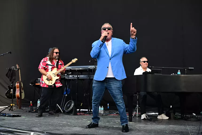 a Billy Joel tribute performer sporting shades and a blue blazer