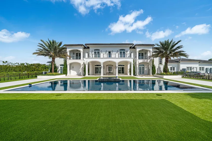 The mansion from the rear, with a reflecting pool behind the house.