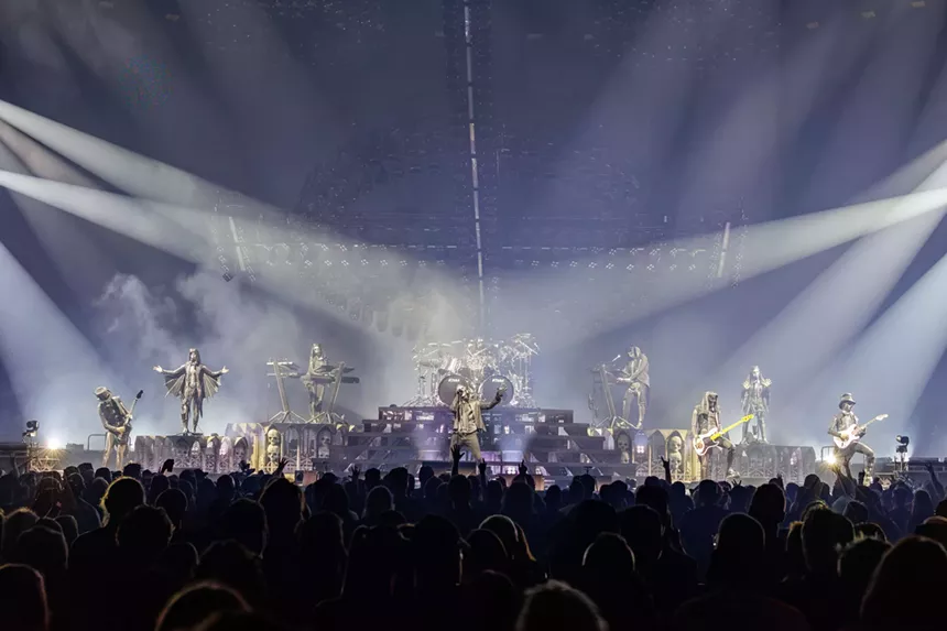 Swedish heavy metal band Ghost on stage with blue lights.