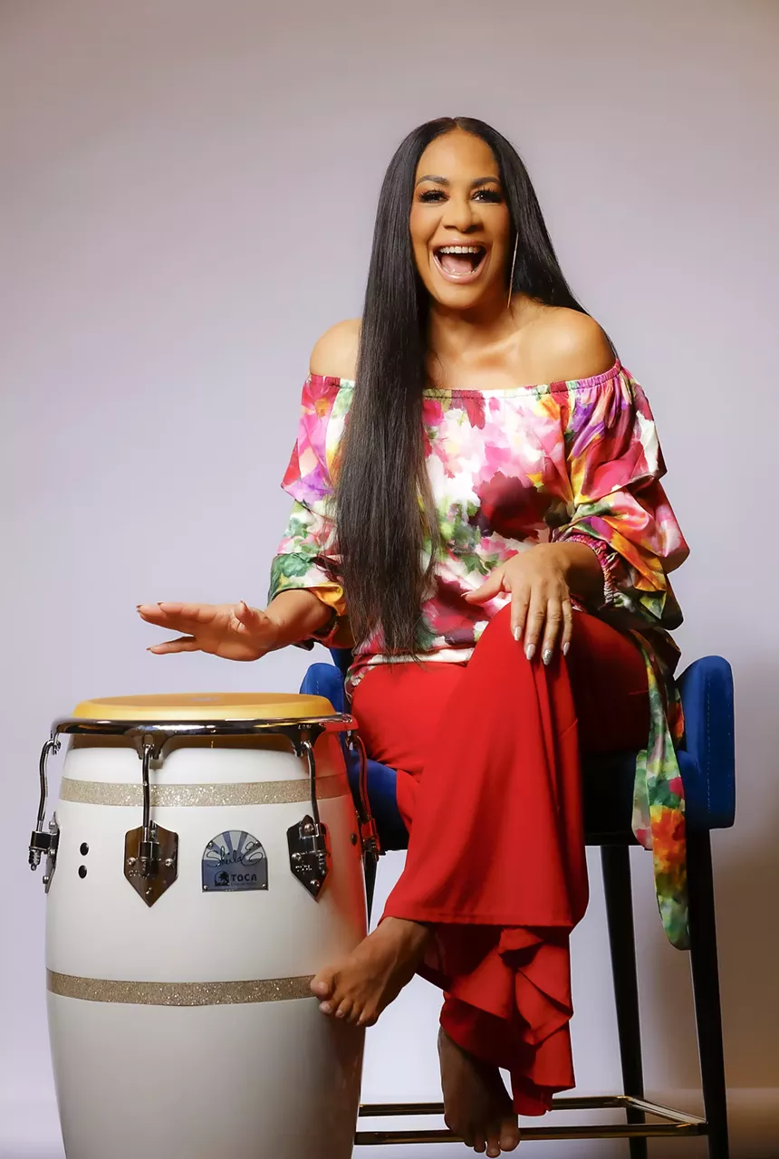 Sheila E. playing conga drums