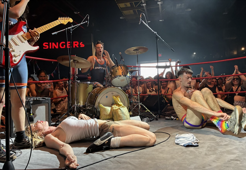 Punk band performing inside a fight ring