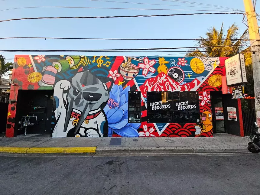 a colorful mural on the facade of a store called Lucky Records