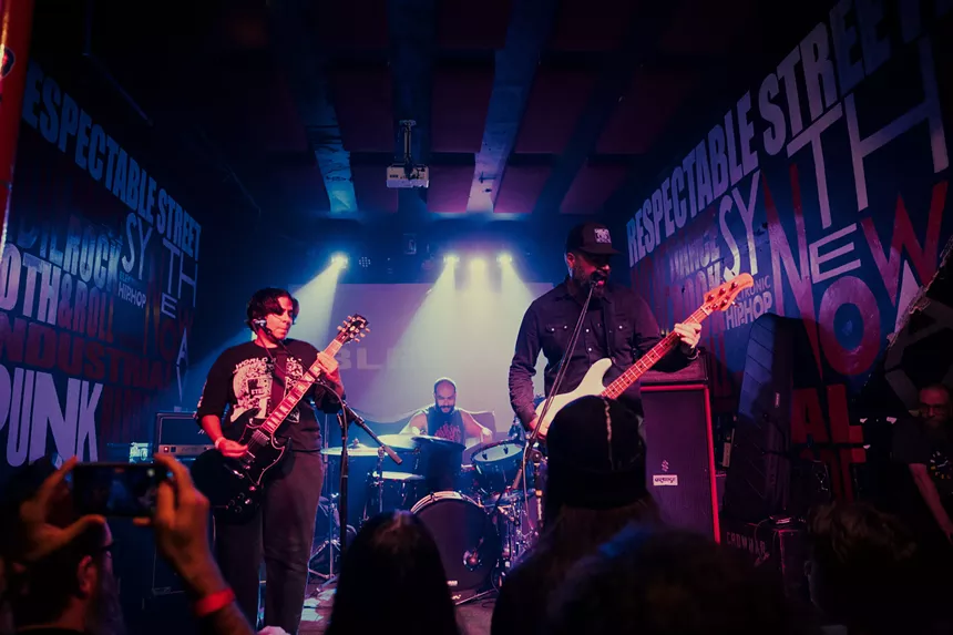 Heavy metal band performing on stage.