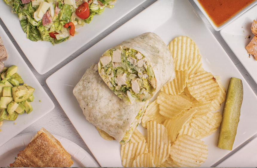 salads and wraps on white plates