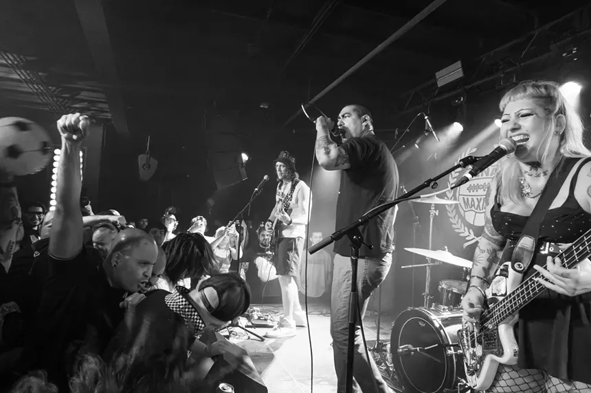 Black and white picture of a band performing on stage.
