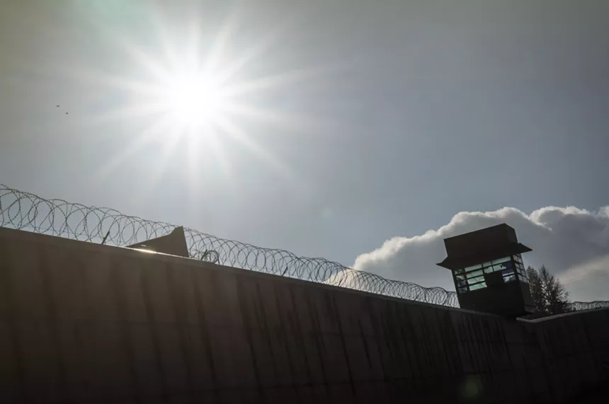 A ray of sun above a barbed wire fence