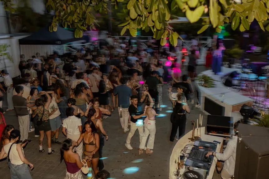 People dancing salsa outdoors.