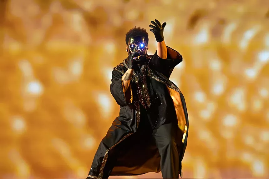Artist The Weeknd on stage in Miami wearing a mask.
