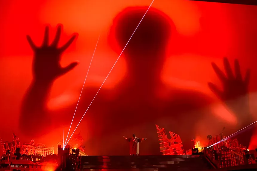 The weekend on stage in front of a screen during the After Hours Til Dawn tour.