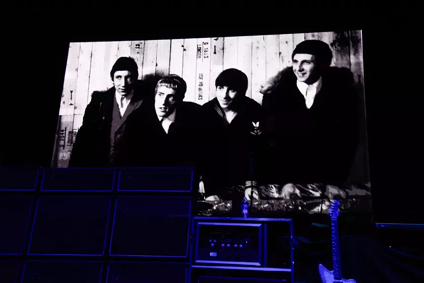 Montage of old interviews of the Who on a stage.