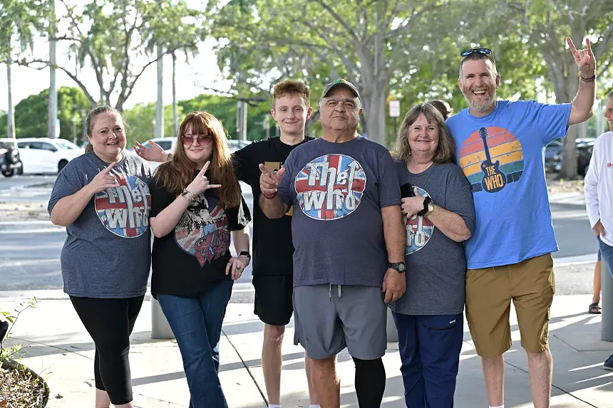 A family wearing The Who's T-shirts during a concert.