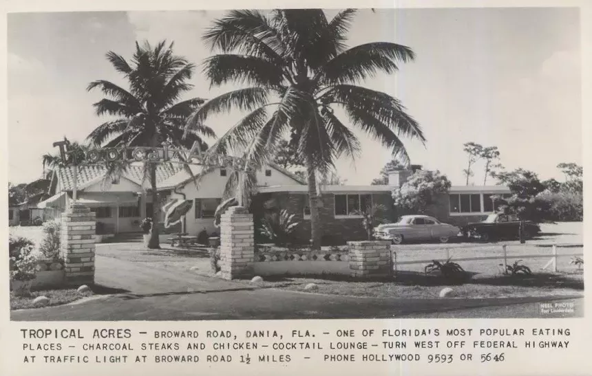 a black and white postcard of the exterior of a restaurant