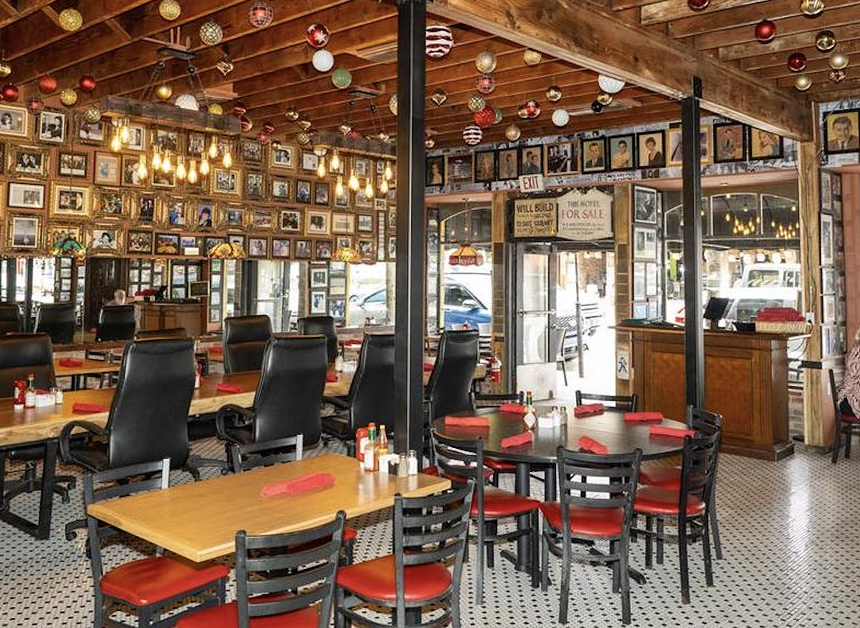 the interior of a dining room with plenty of chairs and a wooden ceiling