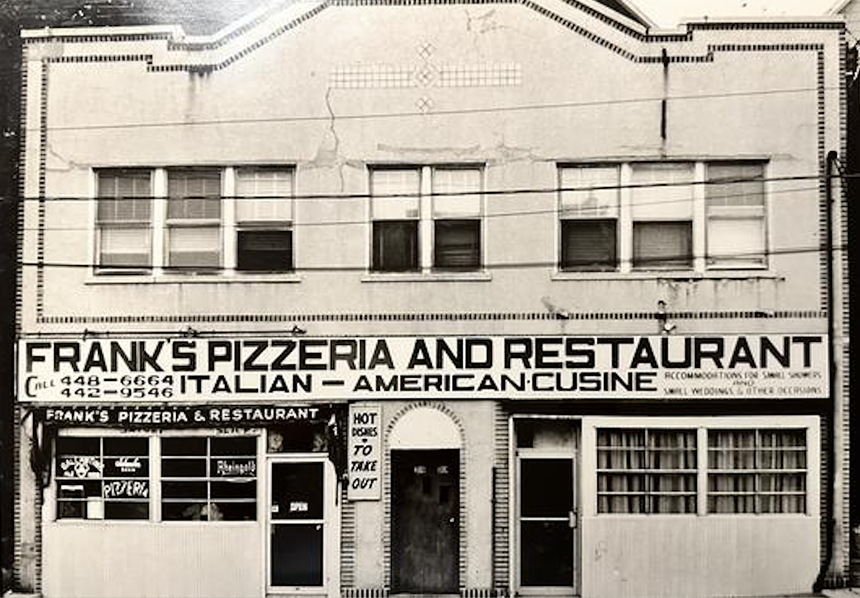 a black and white photo of the exterior of a restaurant