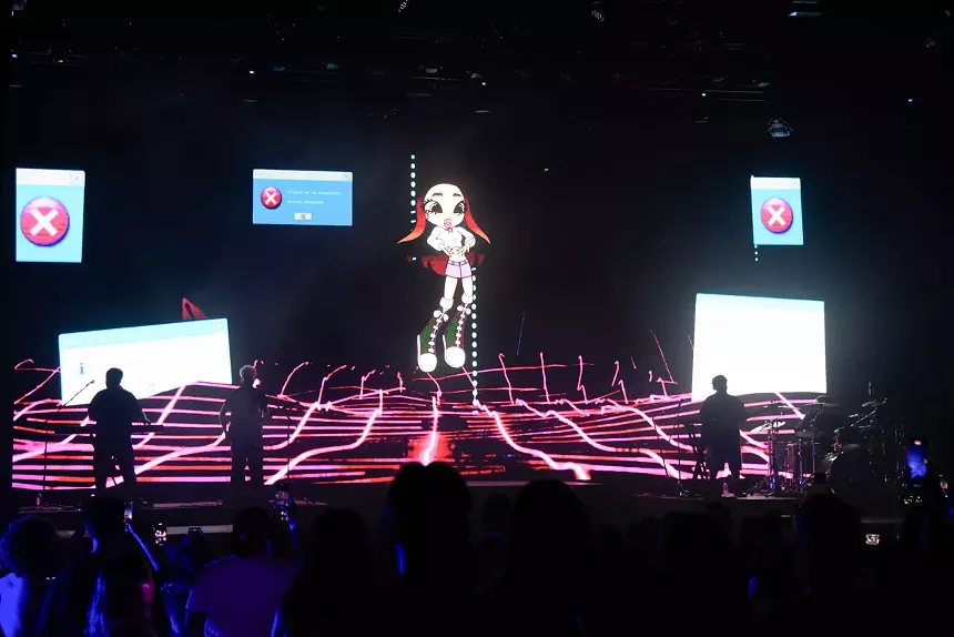 A stage backdrop featuring an anime version of the singer Emilia.