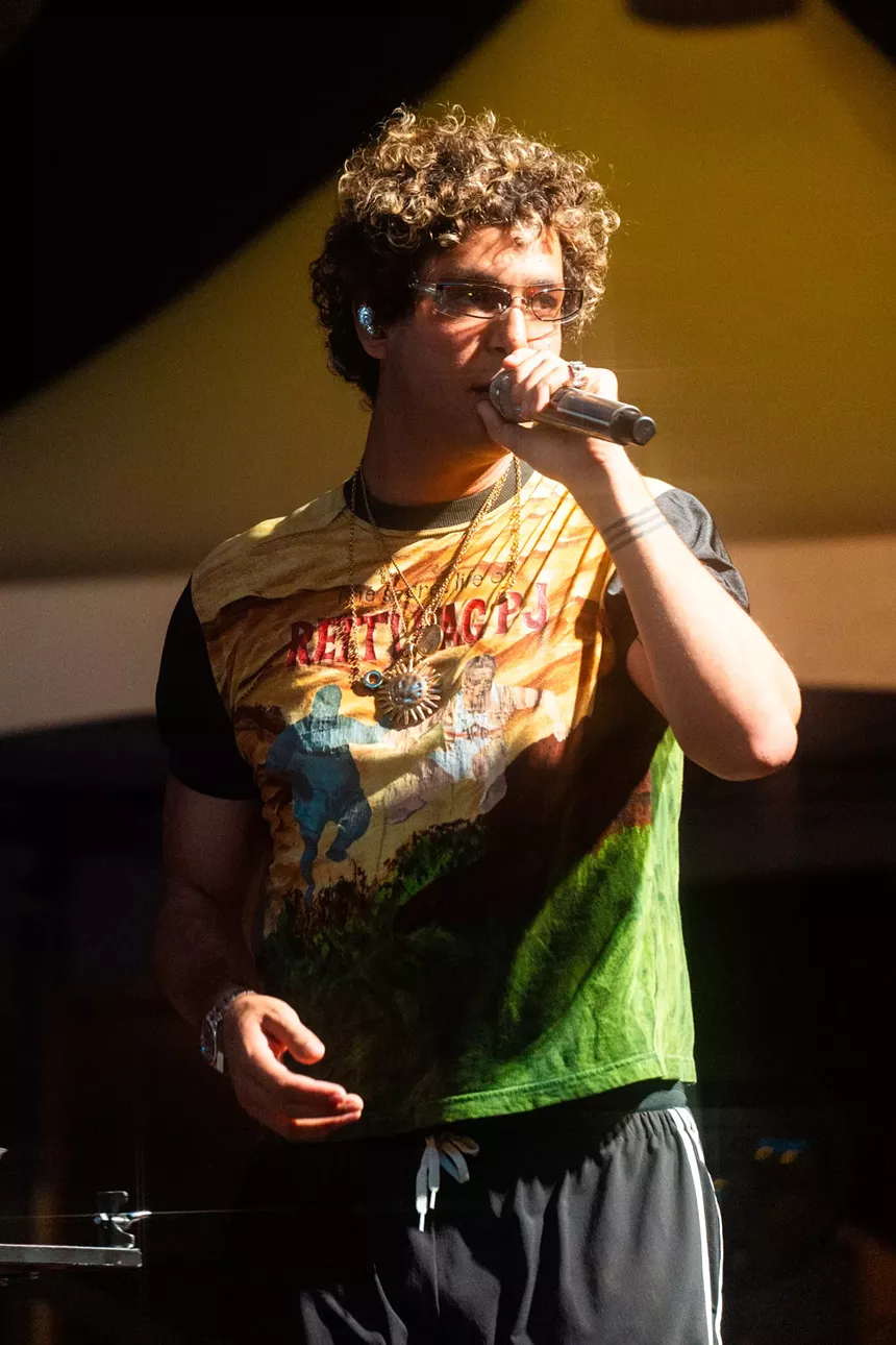Picture of a man singing on stage.