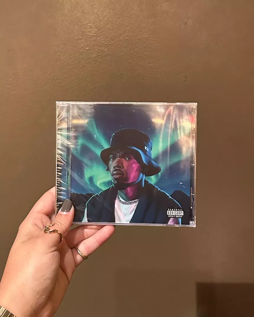 Image of a hand holding a CD