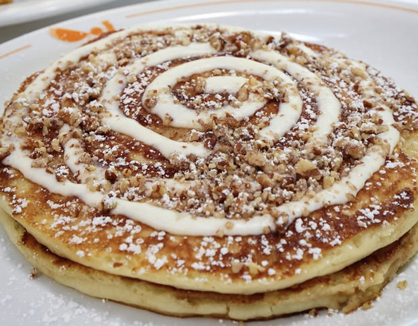 cinnamon roll pancakes with swil on plate