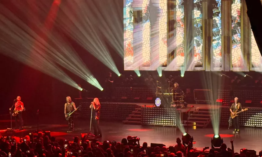 Photo of Def Leppard performing on stage in South Florida.