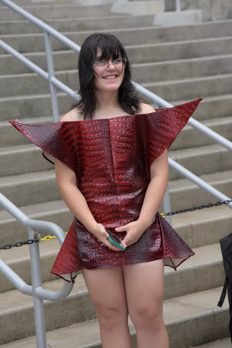 A person wears a geometric snakeskin dress
