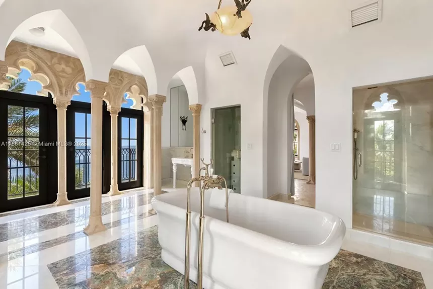 Depicted is a massive tub in a lavish bathroom.