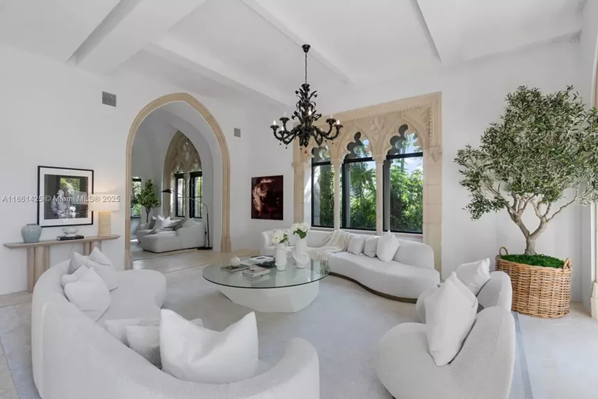 Depicted is a stark white sitting room.