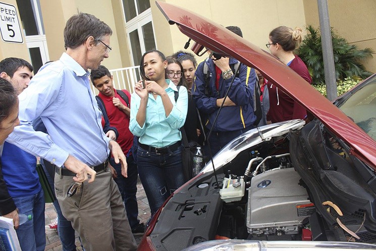 Stoddard shows students his electric Nissan Leaf, which is powered entirely by the solar panels on his South Miami house. - COURTESY OF CITY OF HIALEAH