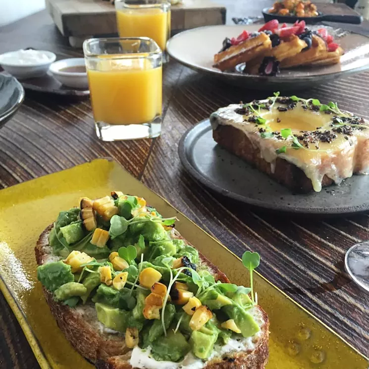 A few brunch favorites are avocado toast, truffled toad in the hole, and berry waffles. - COURTESY OF SUGARCANE