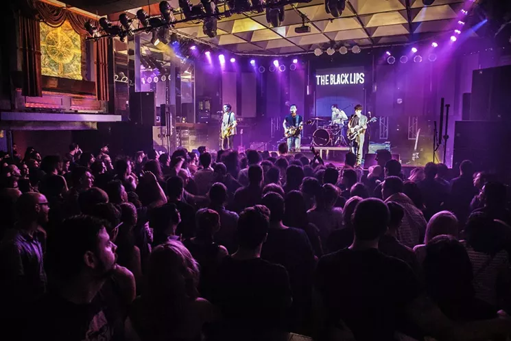For the best view of the stage and a less crowded bar, head to the second floor, grab a drink, and snag a spot on the balcony. - PHOTO BY MONICA MCGIVERN