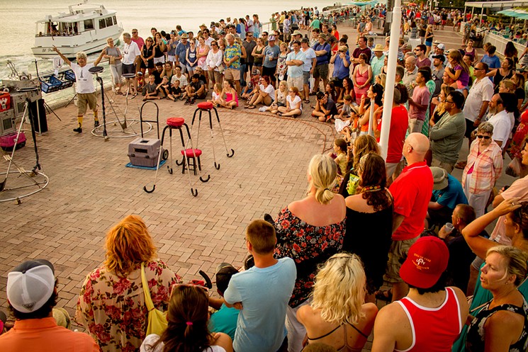Hundreds of people gather each night at sunset to watch Lefort and his cats perform next to the water in Key West. See more photos from Lefort's Mallory Square cat show. - PHOTO BY JAVIER STORCH